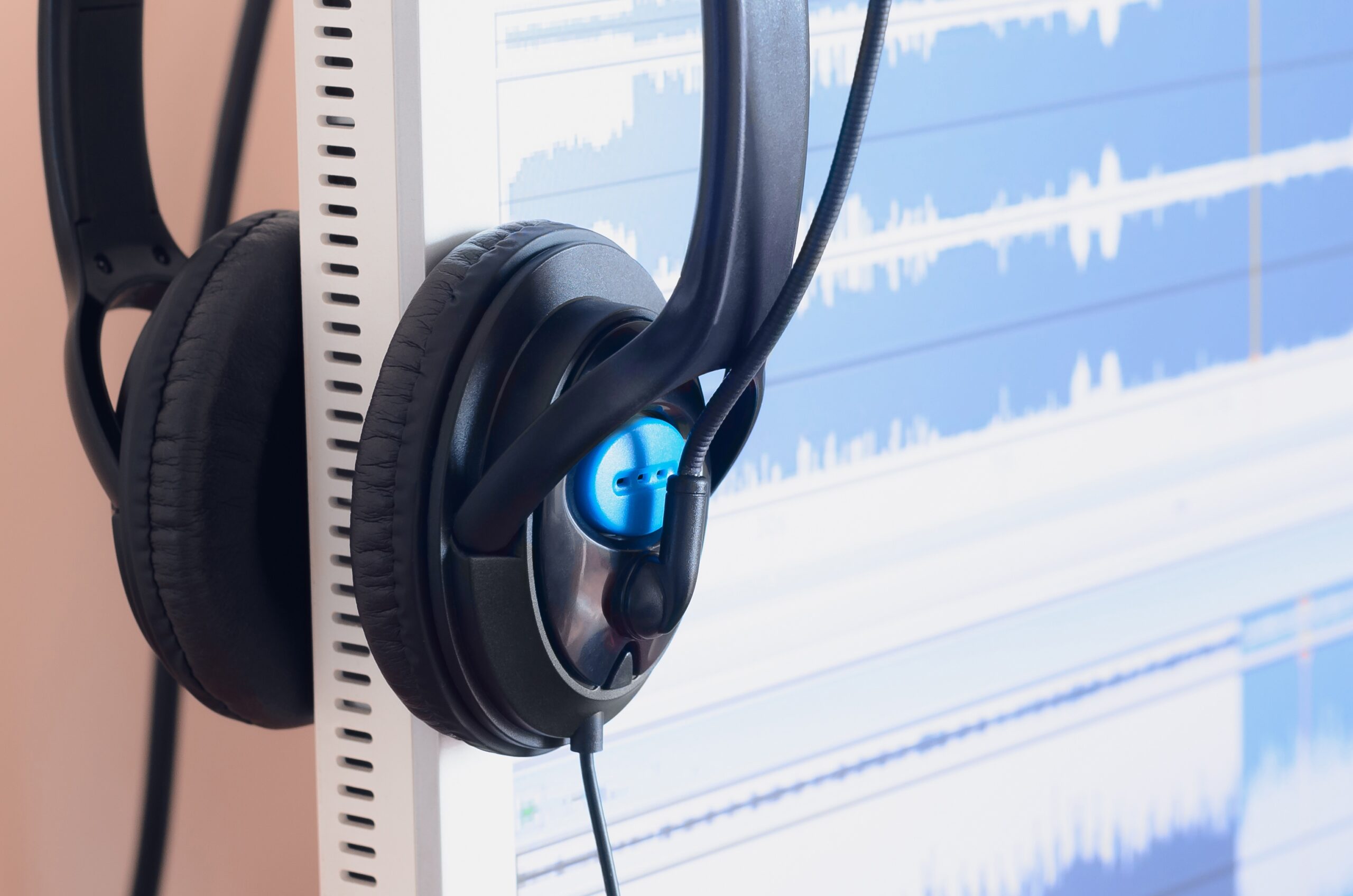 big black headphones lie on the wooden desktop of the sound designer